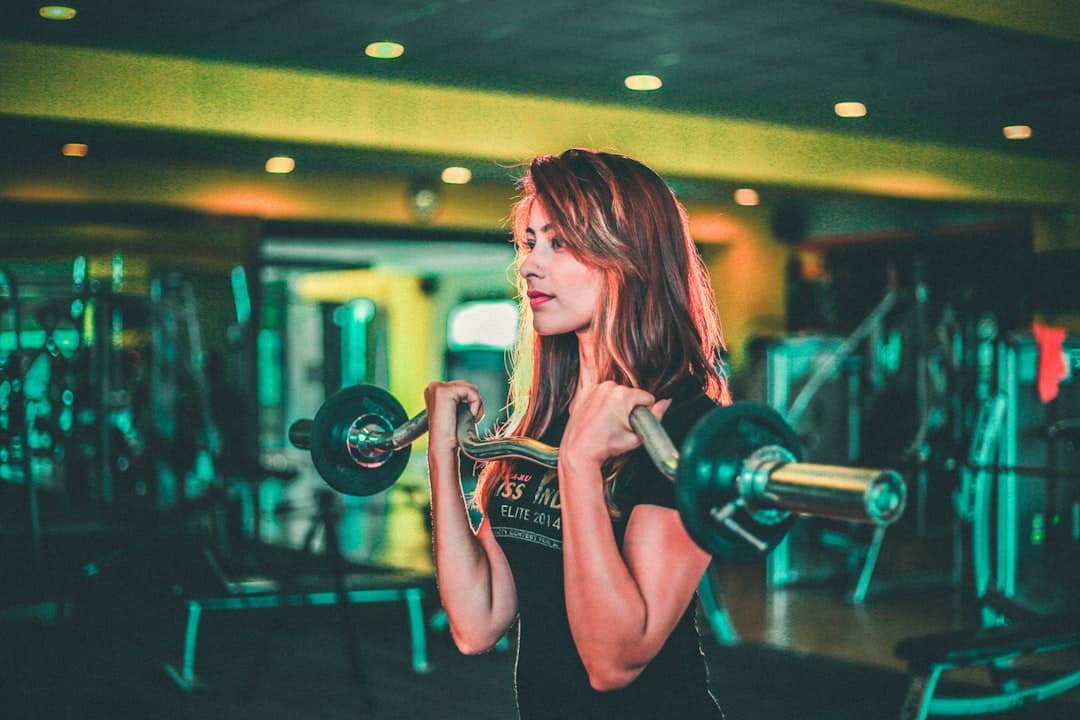 Diverse gym members engaged with a fitness app on their phones, showing active gym member retention strategies in action within a community setting.