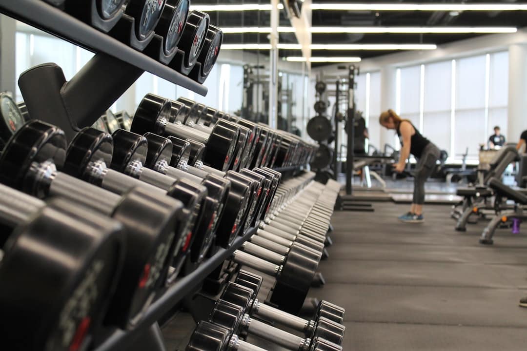 Athlete pushing a heavy sled, demonstrating effort in a gym, highlighting the proactive work to recover failed gym payments.