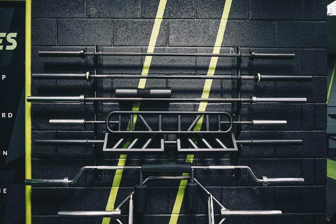 A chalked barbell on a wooden lifting platform representing gym member retention strategies