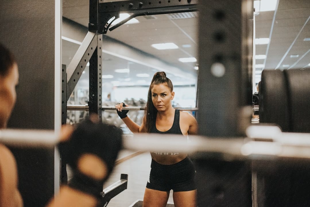 A gym owner speaking with a member on the gym floor, representing automated member engagement and feedback.