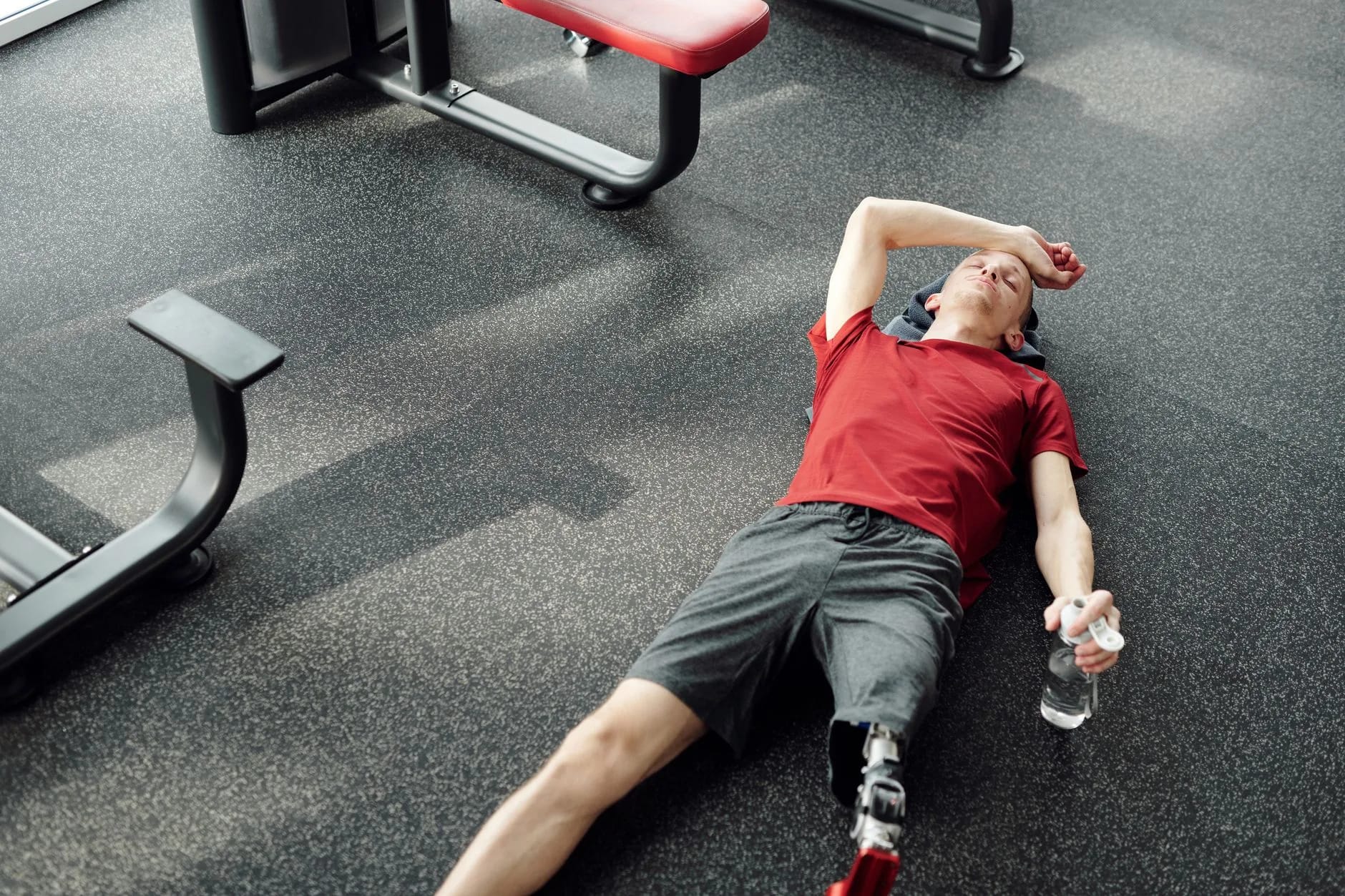 A tired gym member catching their breath after a workout, highlighting the human side of gym member engagement.